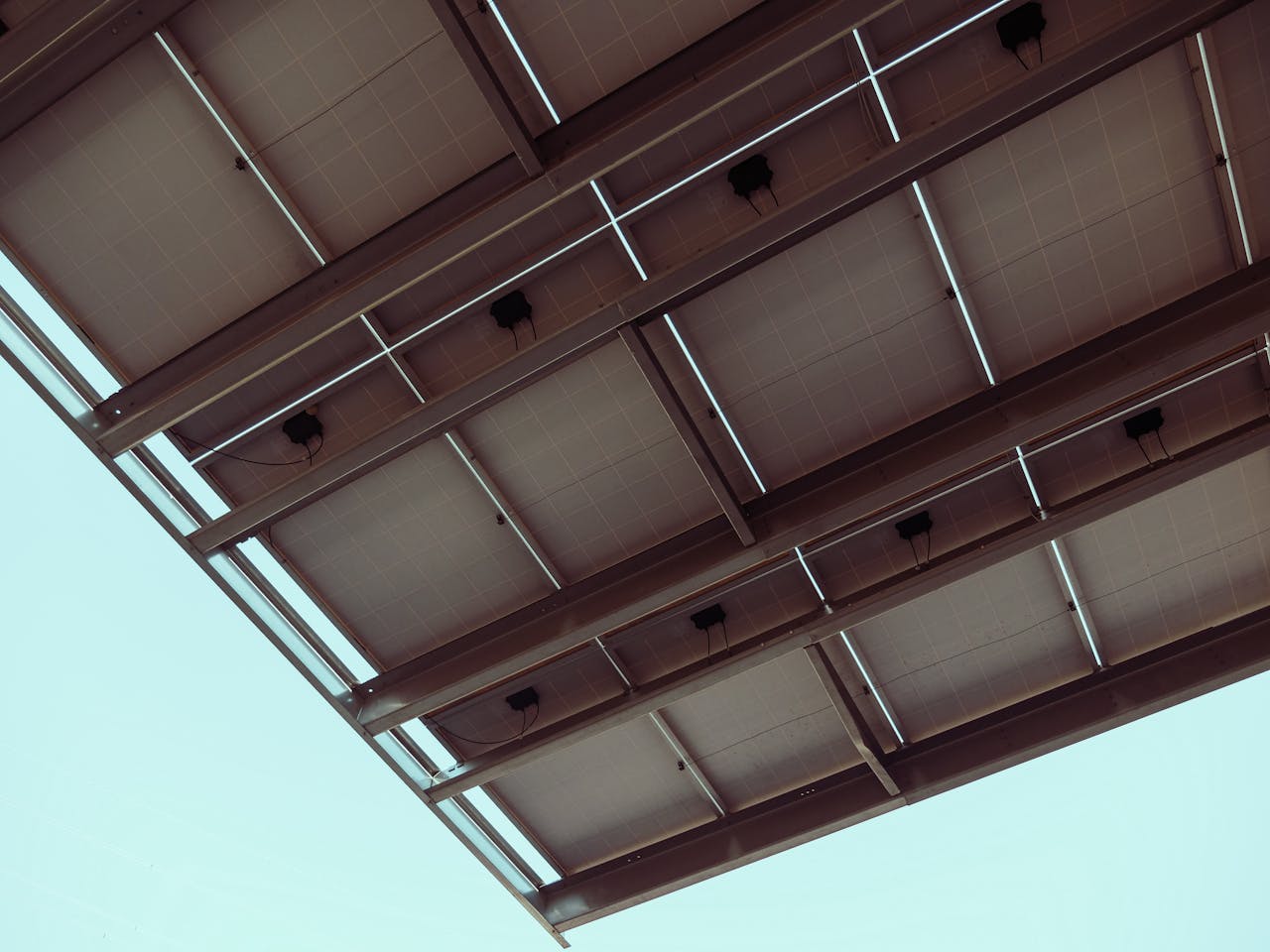 digital-01 Close-up view of solar panels with a blue sky, showcasing renewable energy architecture.